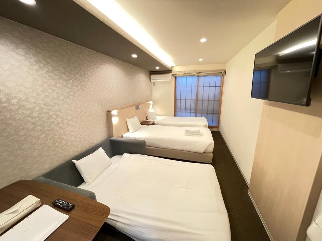 Postel nebo postele na pokoji v ubytování HIZ HOTEL Gion-Shirakawa