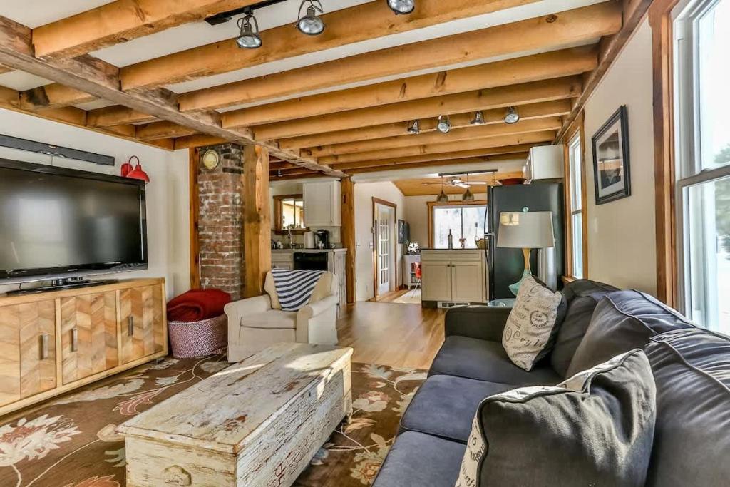 a living room with a couch and a tv at Majestic Mountain Retreat with Fire Pit Facing Mtn in Hunter
