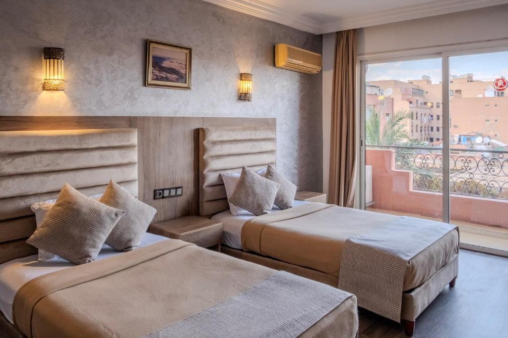 Postel nebo postele na pokoji v ubytování Imperial Holiday Hôtel & spa