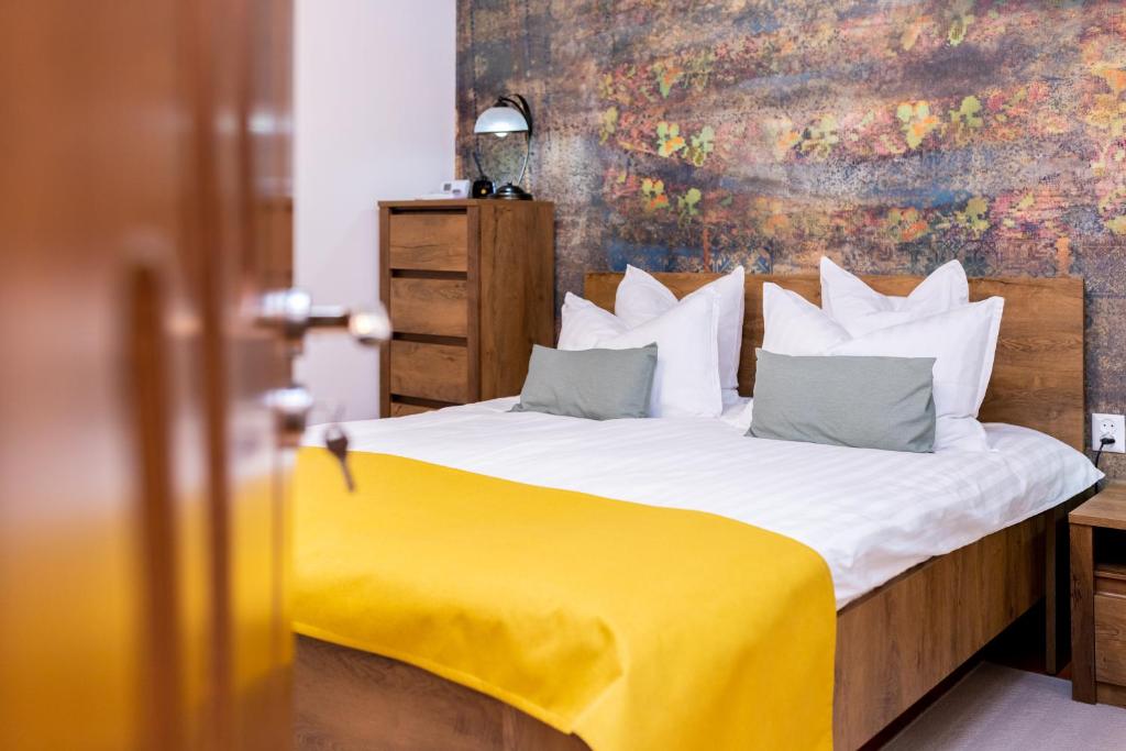 a bedroom with a bed with a yellow blanket at Apartament Octavia in Hunedoara