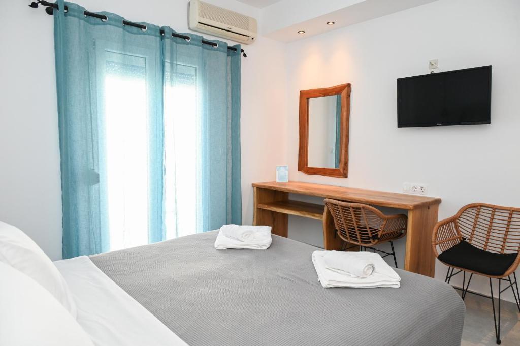 Postel nebo postele na pokoji v ubytování Glaronisia Hotel