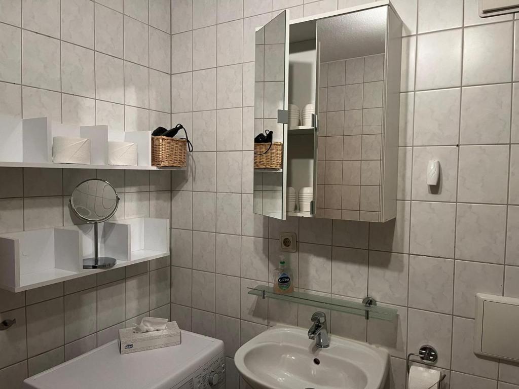 a white bathroom with a sink and a mirror at Apartment 3 Große Brüdergasse in Bautzen