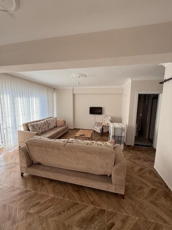 a living room with a couch and a tv at İlkay suit in Bandırma