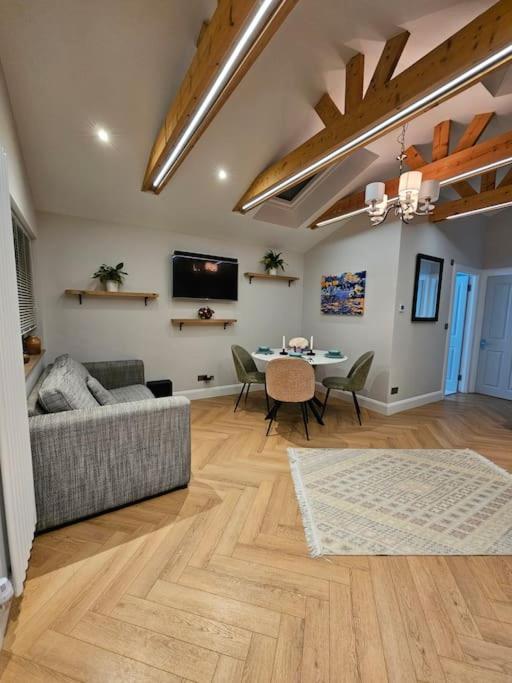 a living room with a couch and a table at Little Cottage Oassis in Dublin