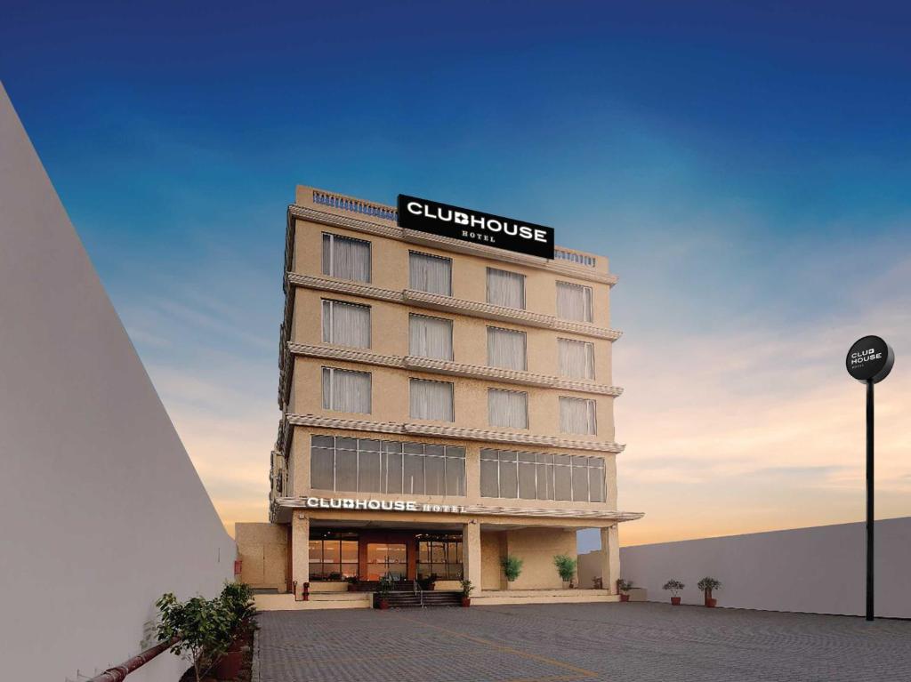 a building with a sign on top of it at Clubhouse Hotel by CheckIn Morbi in Morbi