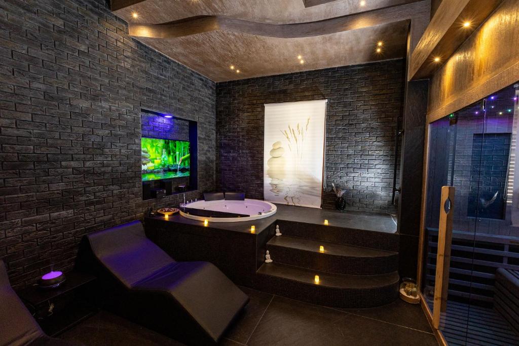 a bathroom with a tub and stairs and a tv at Lungomare Suite & Spa in Naples
