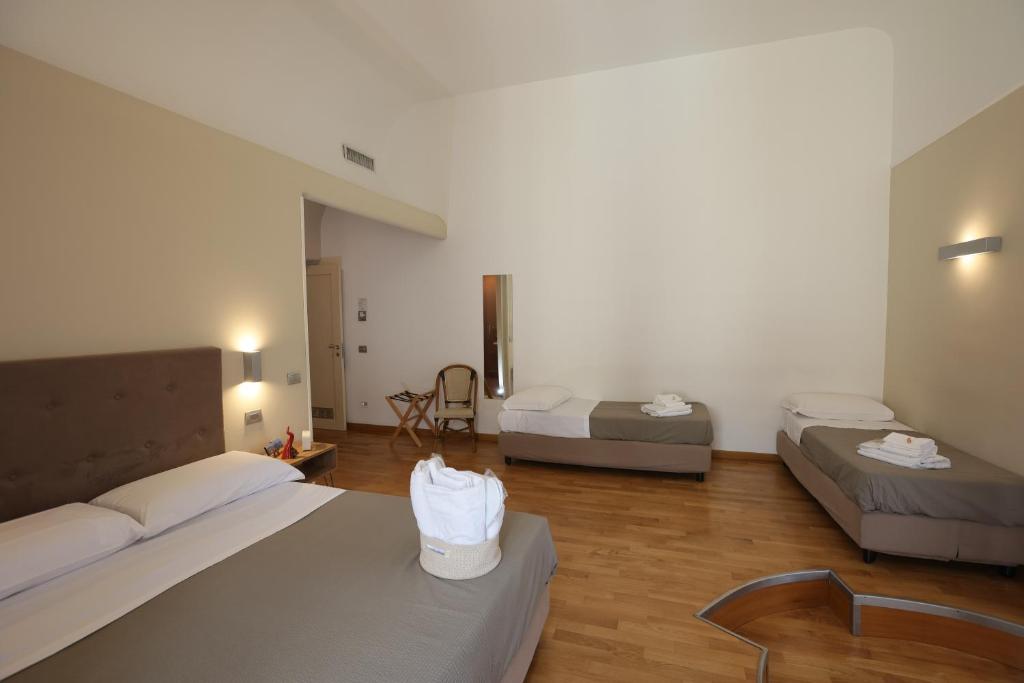 a large room with two beds and a table at Lungomare Suite & Spa in Naples