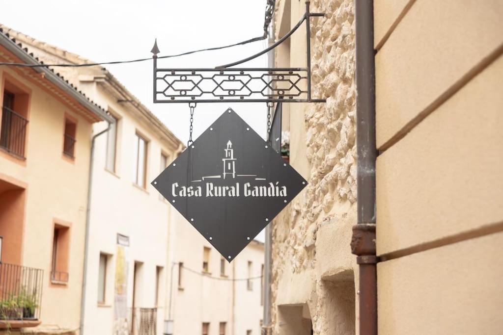 a sign hanging from the side of a building at Casa Rural Gandia in Bocairent
