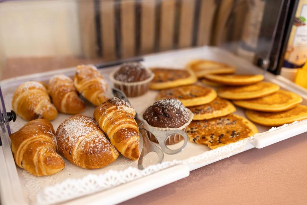 a tray filled with different types of pastries and donuts at Lungomare Suite & Spa in Naples
