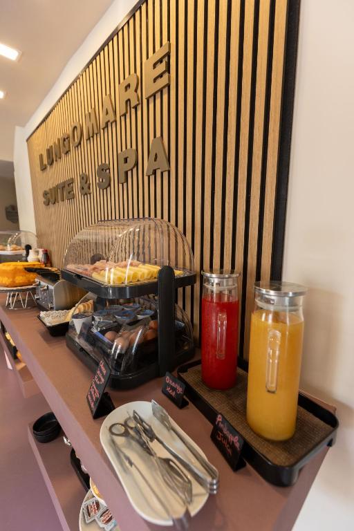 a table with utensils and drinks on a counter at Lungomare Suite & Spa in Naples