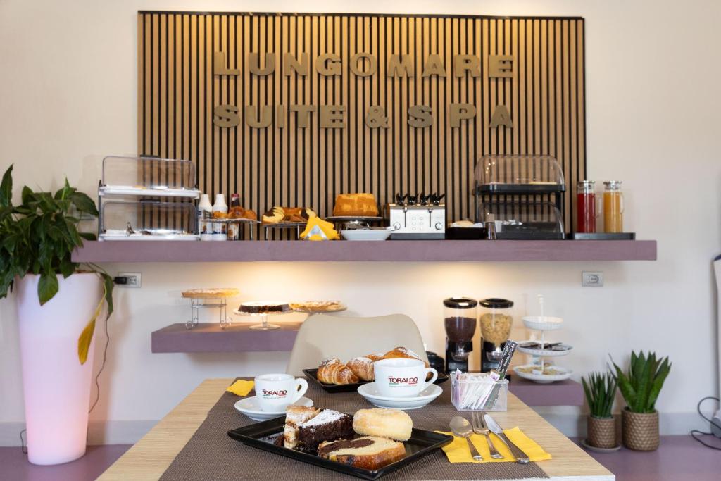 a table with a tray of food on it at Lungomare Suite & Spa in Naples