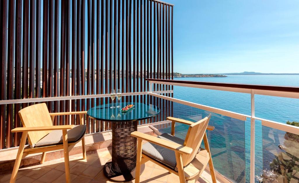 a balcony with a table and two chairs and the ocean at Hotel de Mar Gran Meliá - Adults Only - The Leading Hotels of the World in Illetas