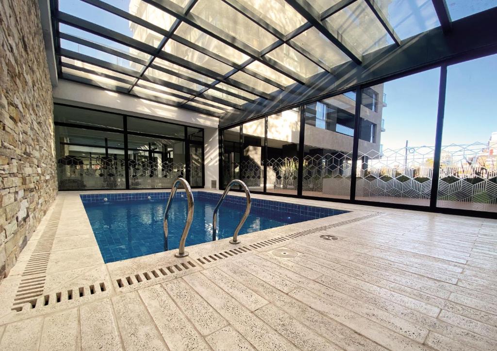 a swimming pool in a house with a large window at Pionero in Neuquén