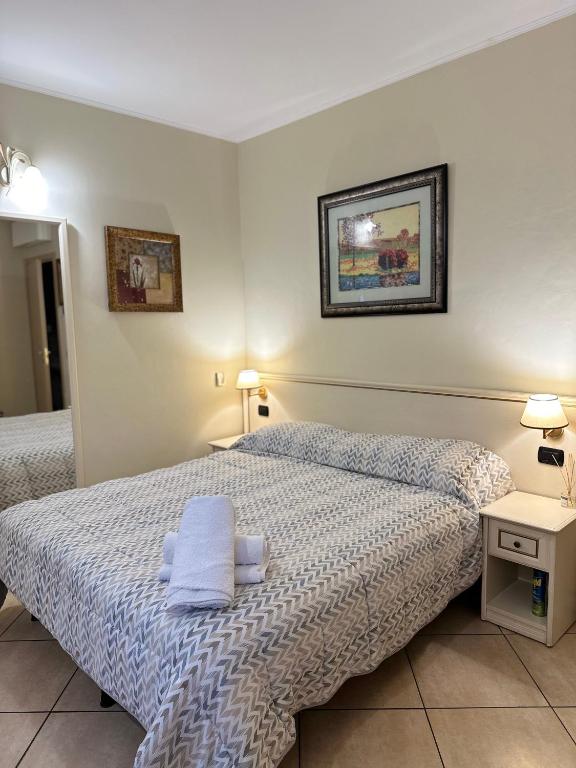 Hotel Camere Chicca, a bedroom with two beds with towels on them at Camere Chicca in Sanremo