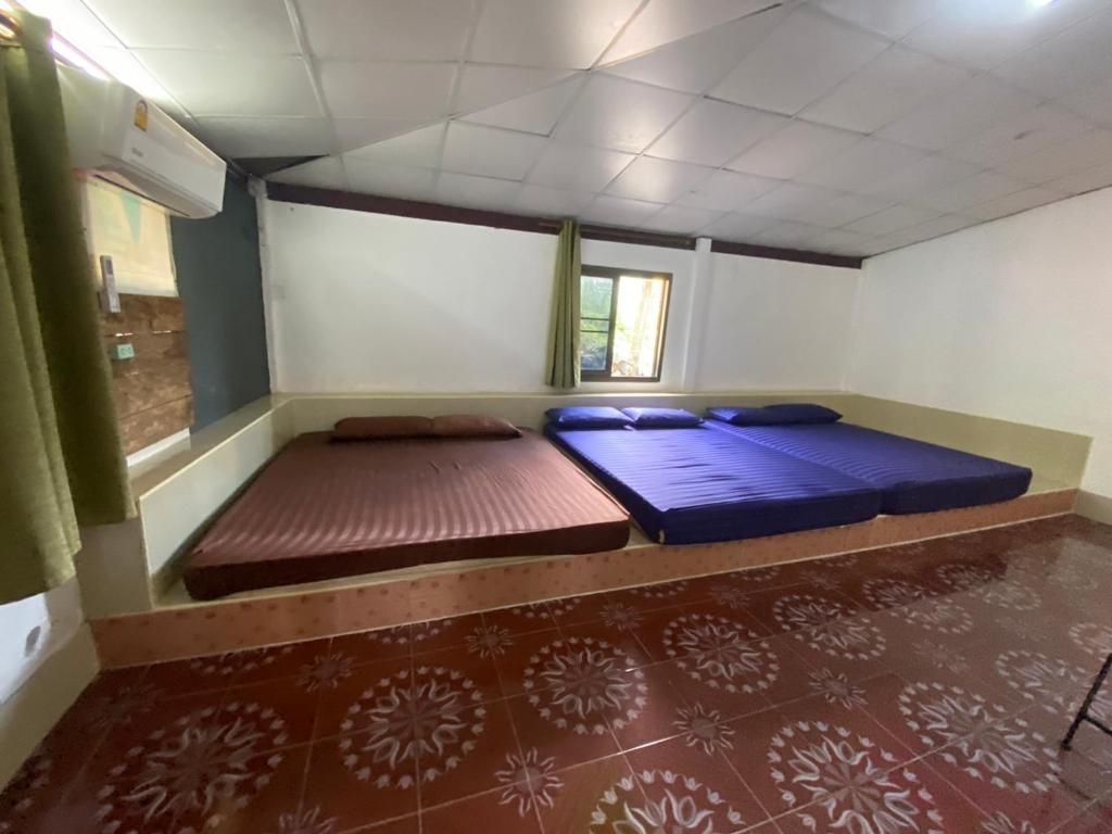 Postel nebo postele na pokoji v ubytování บ้านอัคคนี-Baan AUCKANEE