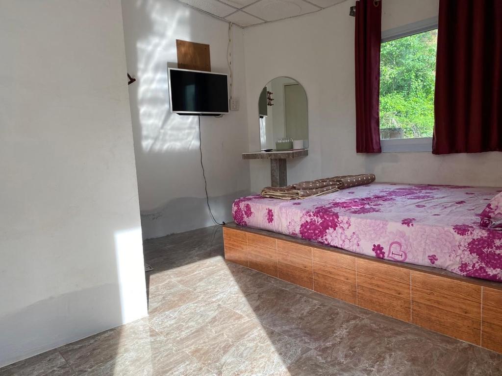 Postel nebo postele na pokoji v ubytování บ้านอัคคนี-Baan AUCKANEE