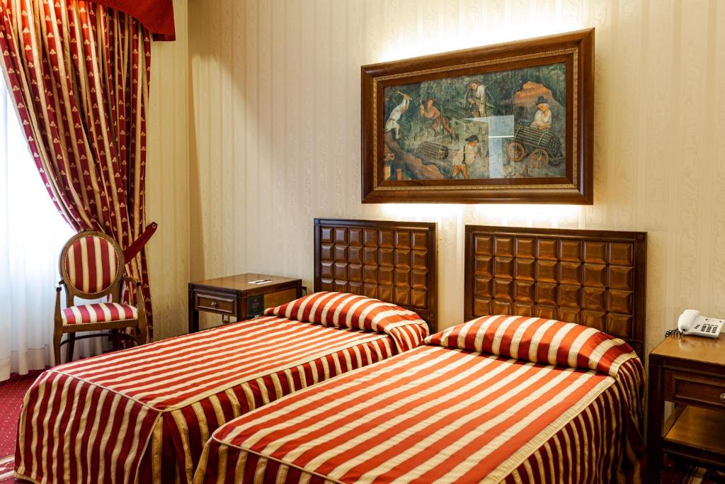 Posteľ alebo postele v izbe v ubytovaní Grand Hotel Trento