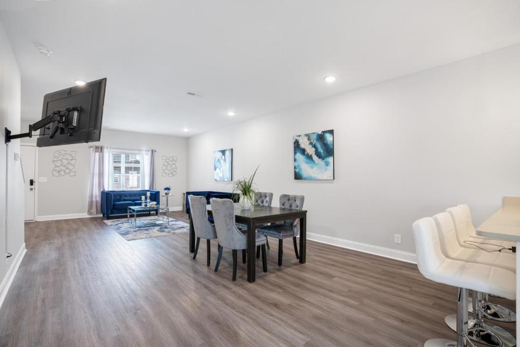 a dining room and living room with a table and chairs at Waiting to Excell in Clarksville