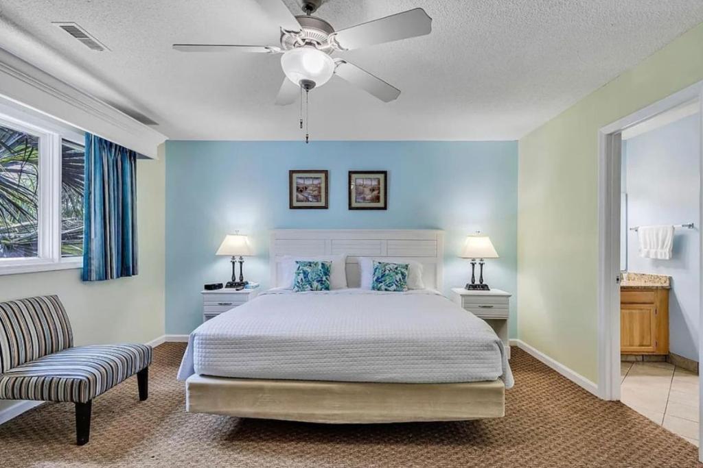 a bedroom with a bed and a ceiling fan at Pelicans Reef by the beach in Myrtle Beach