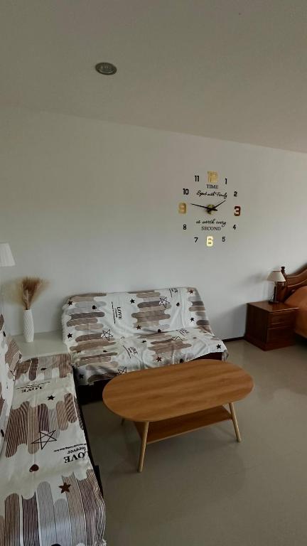 a room with two beds and a clock on the wall at Apartment in Koh Samui