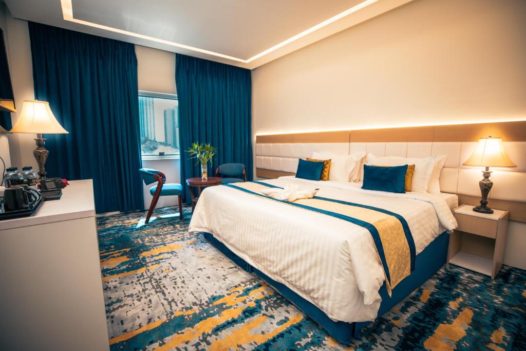 Postel nebo postele na pokoji v ubytování Taj Park Hotel