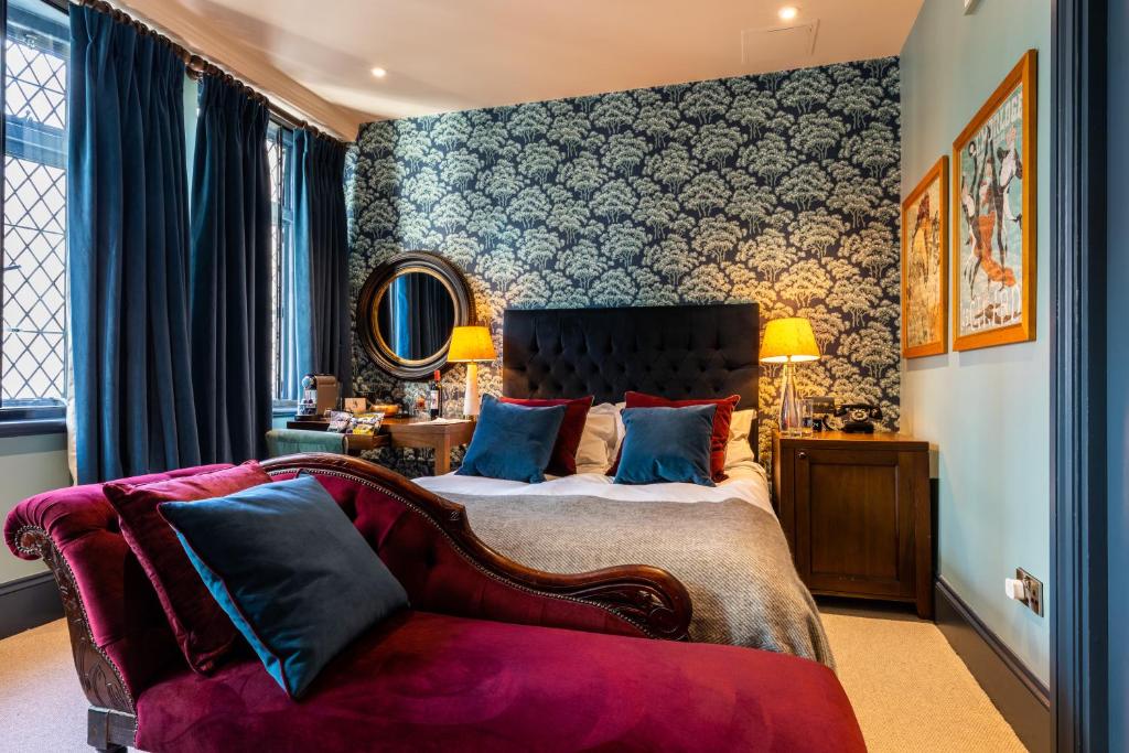 a bedroom with a large bed and a couch at Fox and Anchor in London