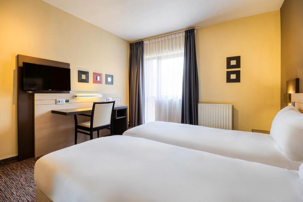 Postel nebo postele na pokoji v ubytování B&B HOTEL Mons Centre