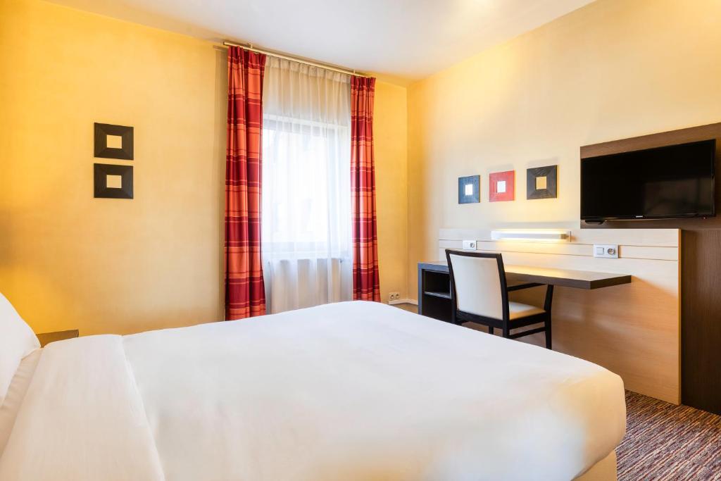 Postel nebo postele na pokoji v ubytování B&B HOTEL Mons Centre