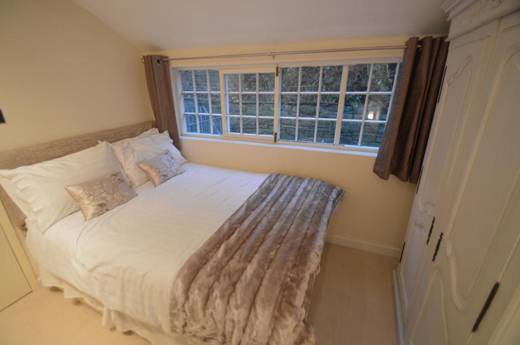 a bedroom with a large bed with a window at Wg Apartment in Macclesfield