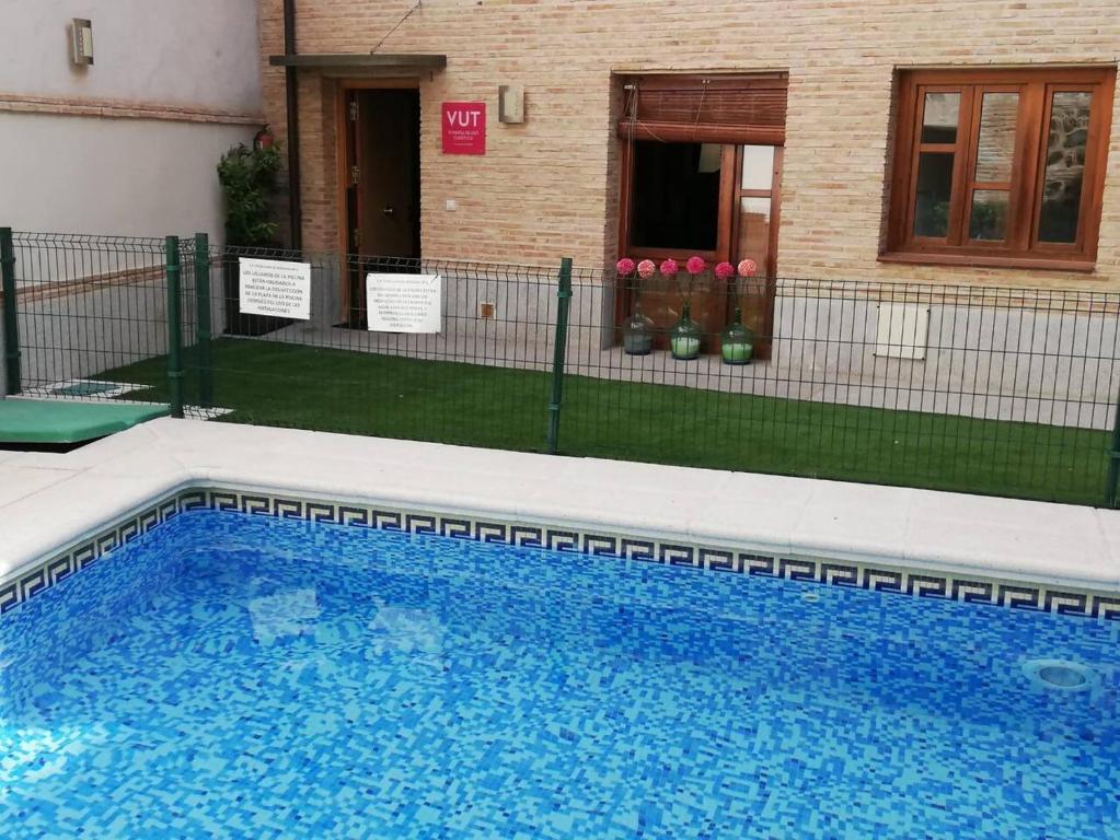 a swimming pool in front of a house at La Dama del Jardín del Nuncio in Toledo
