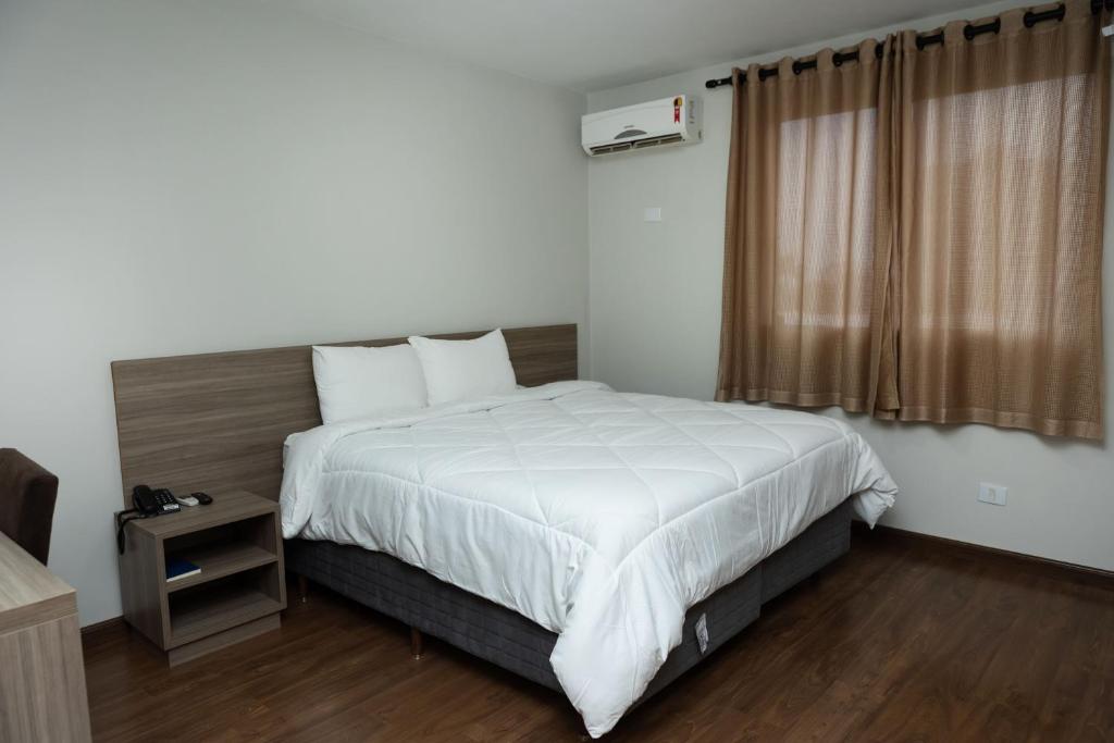Postel nebo postele na pokoji v ubytování Arca's Hotel Umuarama
