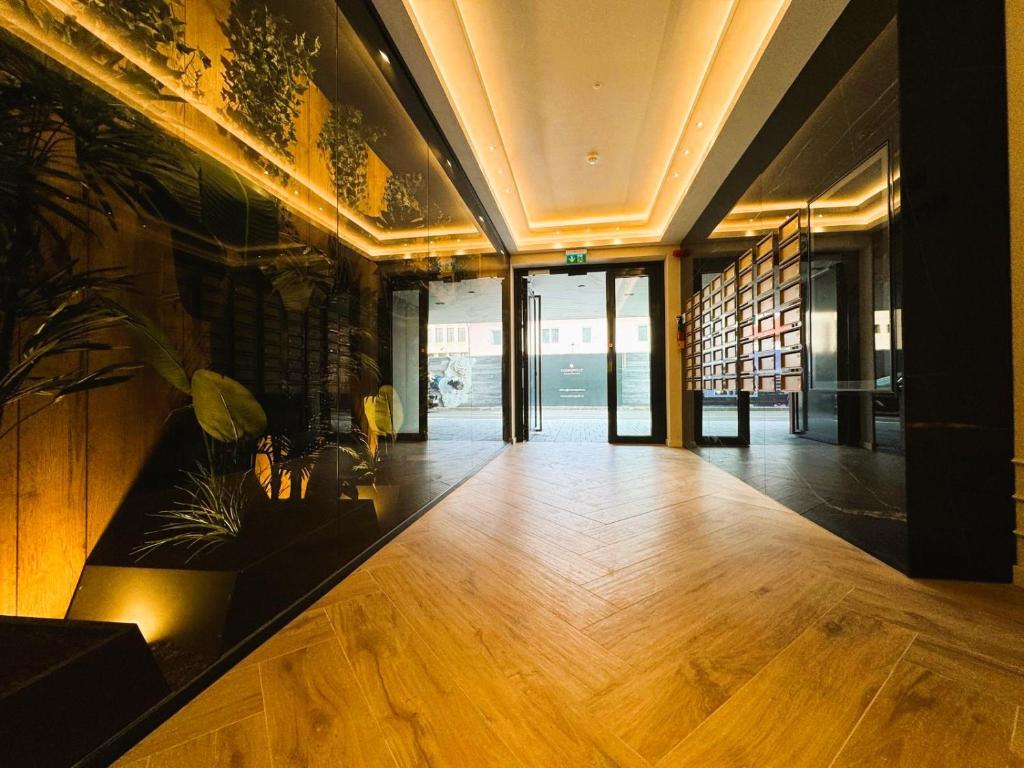 an office lobby with a wooden floor and glass doors at Chic Center Apartament in Braşov