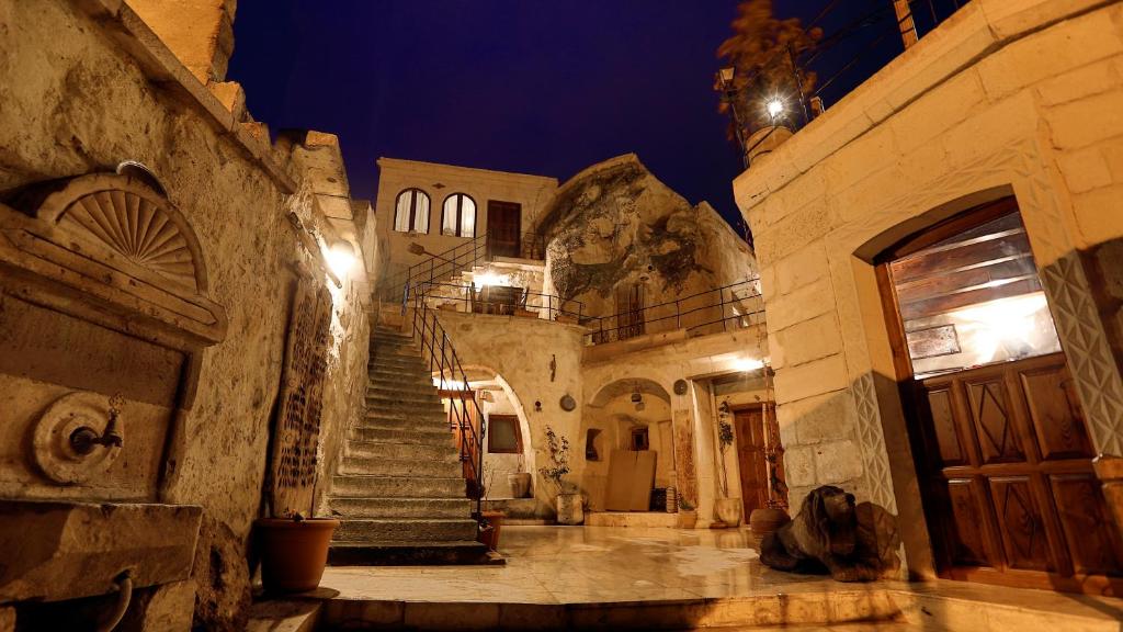 an old building with a staircase and a door at Turquaz Cave Hotel in Göreme