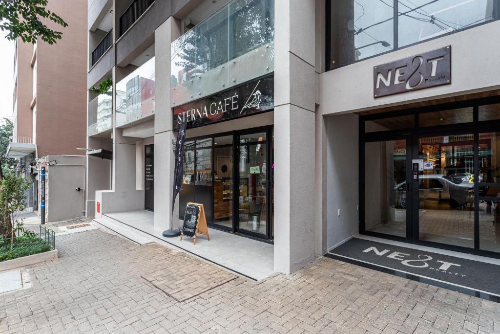 uma loja na frente de um edifício com um sinal na janela em Next Paulista by Viva - Apartamentos completos ao lado da Av Paulista e MASP em São Paulo