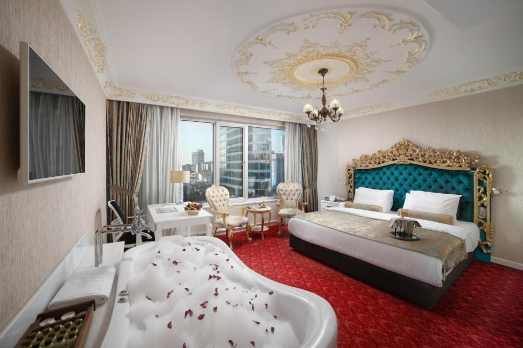 a hotel room with a bed and a bath tub at White Monarch Hotel in Istanbul