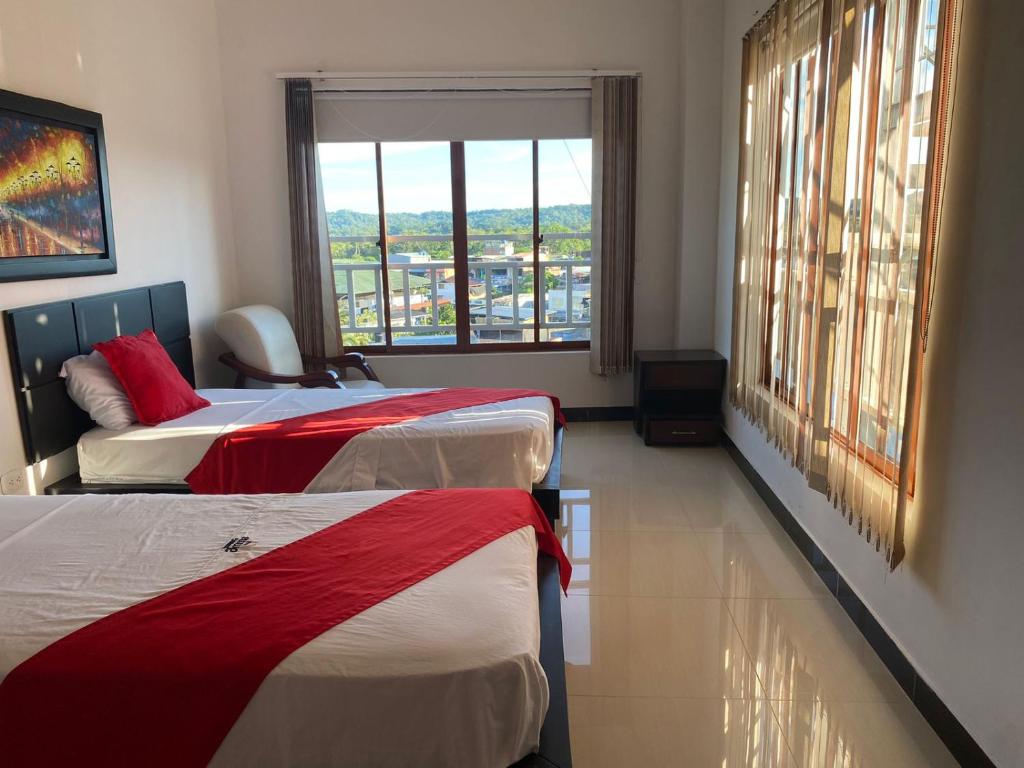 Postel nebo postele na pokoji v ubytování Hotel AMMA