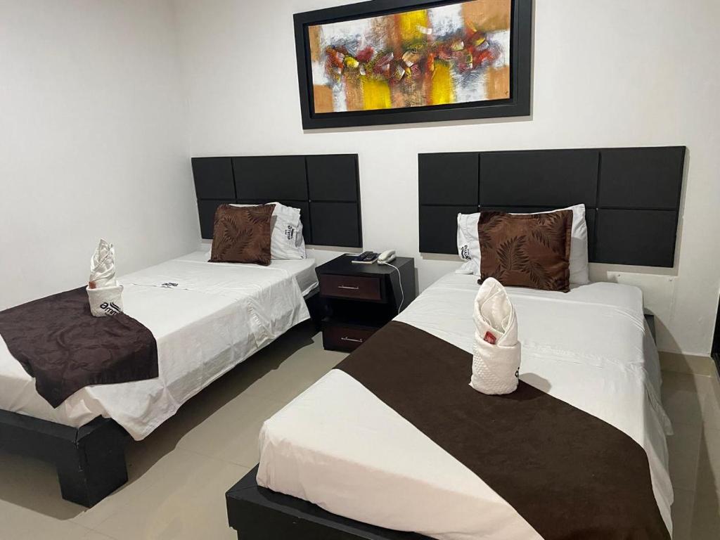 Postel nebo postele na pokoji v ubytování Hotel AMMA