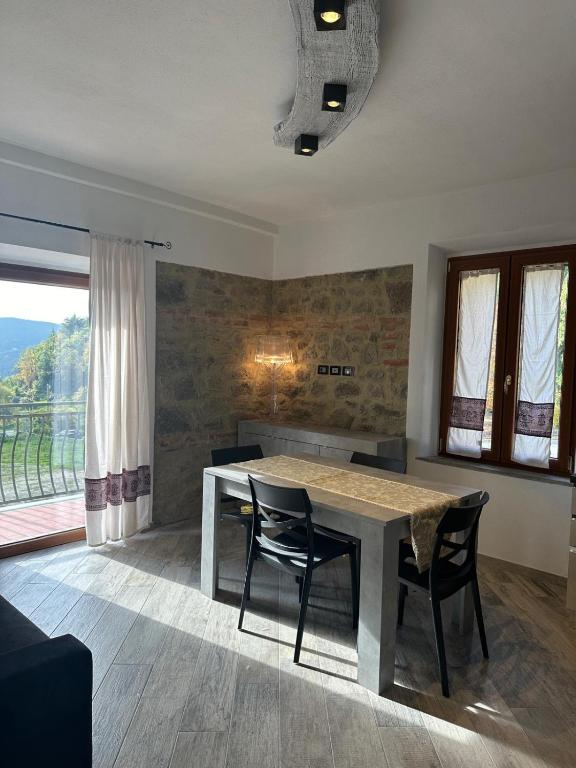 a dining room with a table and two chairs at Casa Gaudi in Piancastagnaio