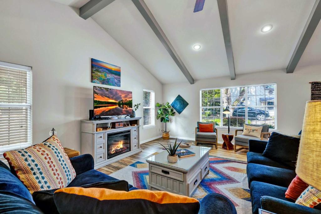 a living room with a couch and a fireplace at Peach Street Retreat - Fire Pit and Close to Main St in Fredericksburg