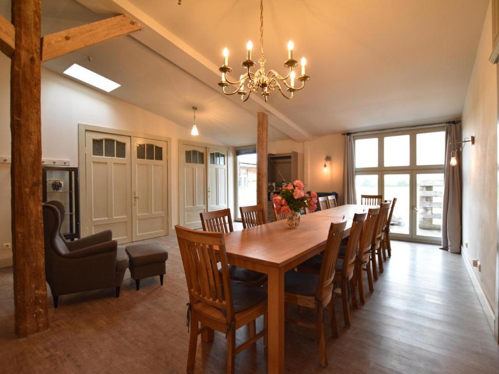 a dining room with a table and chairs at Gutshofblick L in Hanshagen