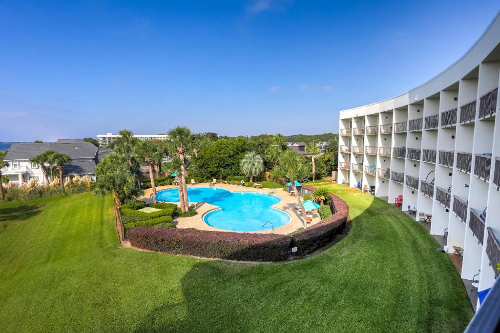 an aerial view of a hotel building with a swimming pool at Pirates Bay Condominiums Unit 302A in Fort Walton Beach