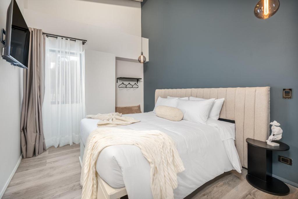 Postel nebo postele na pokoji v ubytování Nago Hometel Boutique