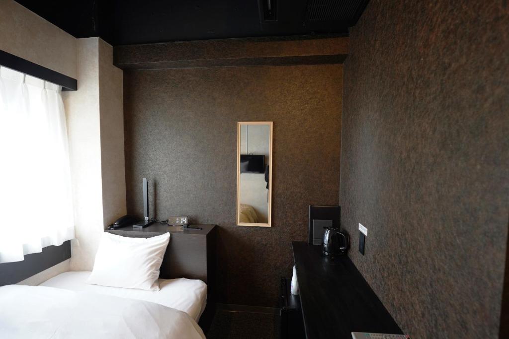 Postel nebo postele na pokoji v ubytování Hotel Chino