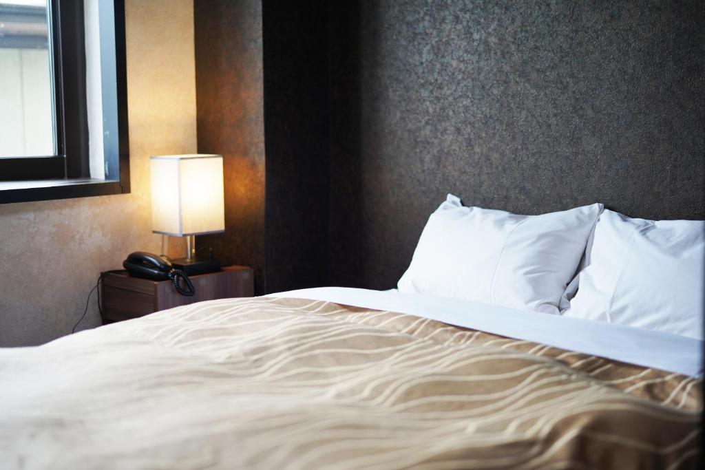 Postel nebo postele na pokoji v ubytování Hotel Chino