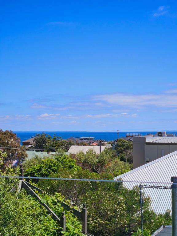 a view of the ocean from the roof of a building at By The Seaside in Mornington