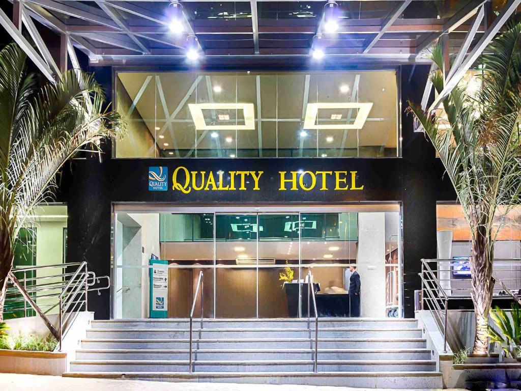 a man standing in front of a luxury hotel at Quality Hotel Pampulha & Convention Center in Belo Horizonte