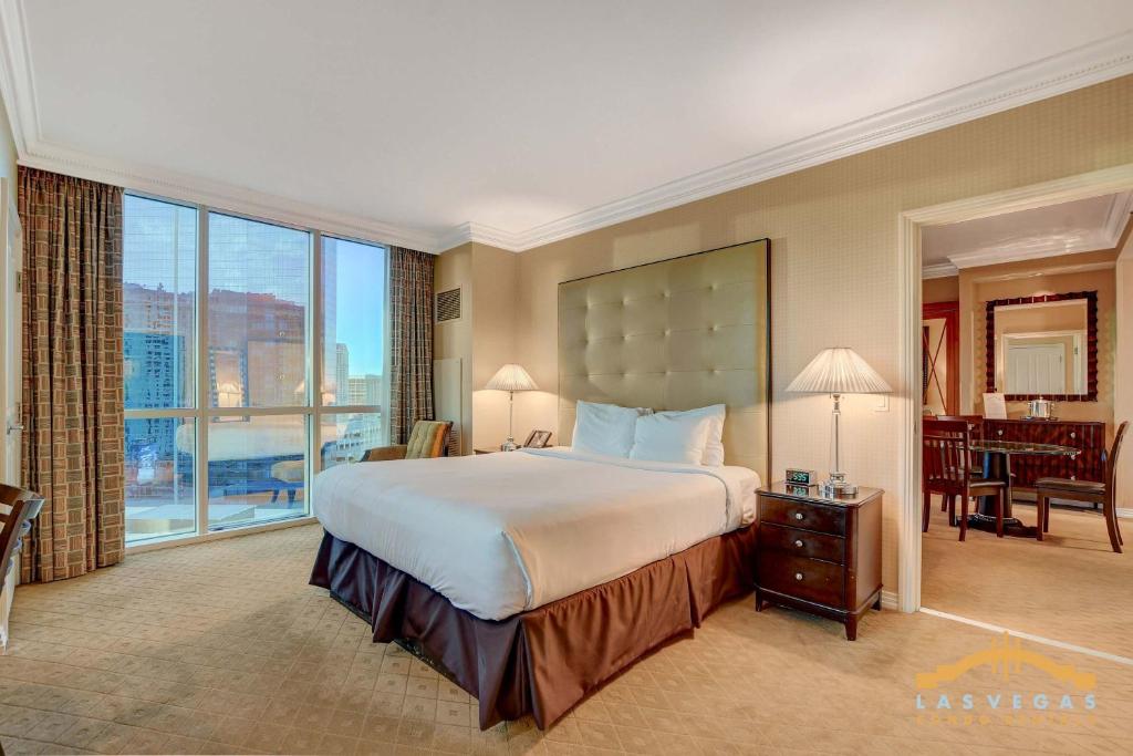a bedroom with a large bed and a large window at MGM Signature-17-801 1Br2Ba F1 Strip View Balcony in Las Vegas