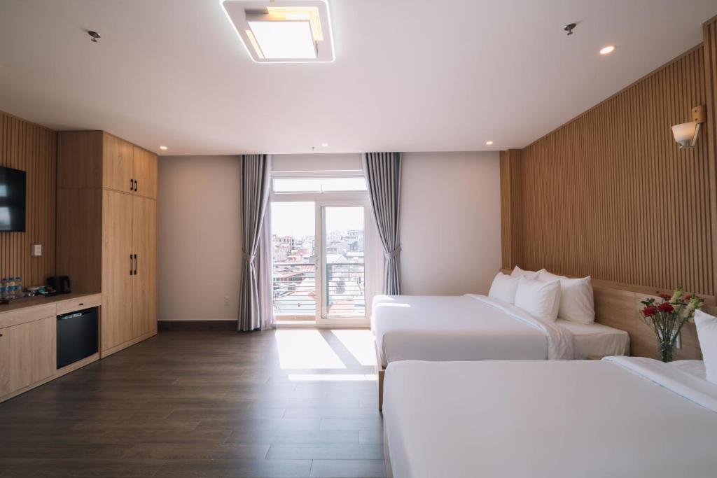 Postel nebo postele na pokoji v ubytování HOANG LINH PHAT HOTEL