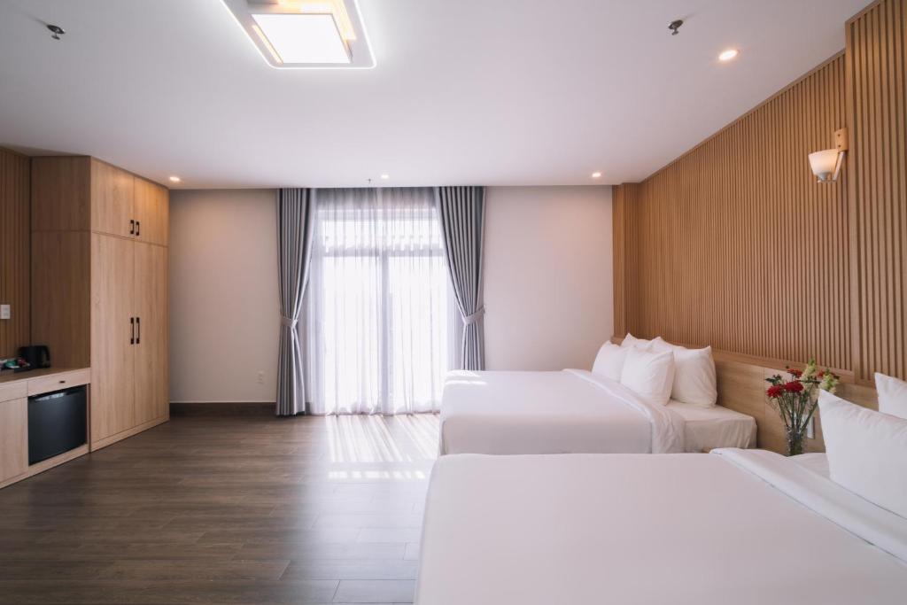 Postel nebo postele na pokoji v ubytování HOANG LINH PHAT HOTEL