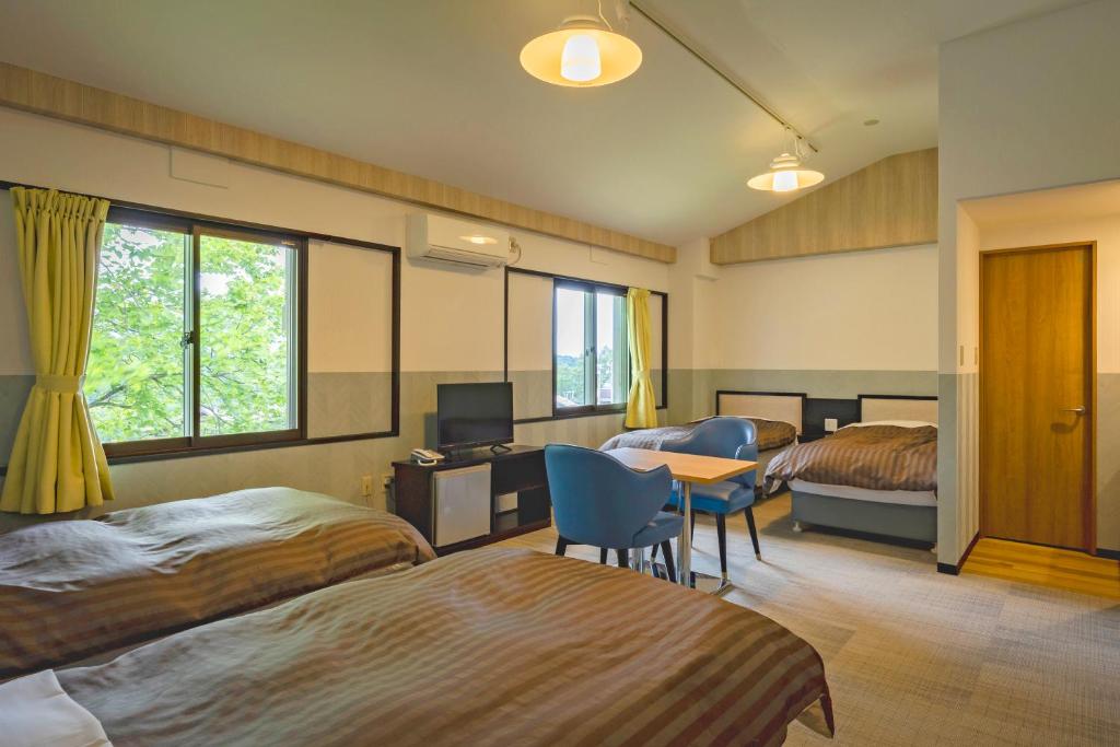 Postel nebo postele na pokoji v ubytování Madarao Kogen Hotel